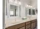 Bright bathroom features double sinks with tan counters, framed mirrors and modern lighting at 3117 S Signal Butte Rd # 501, Mesa, AZ 85212