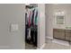 Open walk-in closet leads to bathroom with dual sink vanity and shower at 3117 S Signal Butte Rd # 501, Mesa, AZ 85212