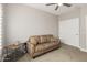 Neutral bedroom with tan sofa, ceiling fan, and closet at 3117 S Signal Butte Rd # 501, Mesa, AZ 85212