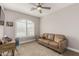 Neutral bedroom with tan sofa, desk, ceiling fan and plantation shutters at 3117 S Signal Butte Rd # 501, Mesa, AZ 85212