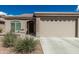 Front exterior view of the house showing the front door and two-car garage at 3117 S Signal Butte Rd # 501, Mesa, AZ 85212