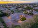 Aerial view of custom home at dusk showcasing landscape, exterior, and neighborhood at 3527 E Indigo Cir, Mesa, AZ 85213