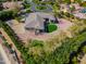 Stunning aerial view of a custom home, with a putting green, manicured landscaping, and circular driveway at 3527 E Indigo Cir, Mesa, AZ 85213