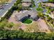 An aerial view of a large, suburban home with a putting green in the backyard at 3527 E Indigo Cir, Mesa, AZ 85213