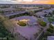 Aerial view of landscaped yard, home exterior, and neighborhood at dusk at 3527 E Indigo Cir, Mesa, AZ 85213