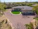 Backyard view showcasing the home with an artificial lawn, decorative features, and desert landscaping at 3527 E Indigo Cir, Mesa, AZ 85213