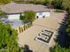 View of the backyard of the home with xeriscaping, mature trees, and decorative hardscape with planters at 3527 E Indigo Cir, Mesa, AZ 85213