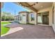 Rear exterior showcasing an expansive covered patio with a turfed backyard and landscaping for outdoor enjoyment at 3527 E Indigo Cir, Mesa, AZ 85213