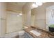 Cozy bathroom featuring granite countertop, modern fixtures, and shower with glass door at 3527 E Indigo Cir, Mesa, AZ 85213