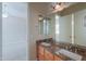 Bathroom featuring a double sink vanity with granite countertops and a large mirror at 3527 E Indigo Cir, Mesa, AZ 85213