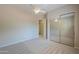 Bedroom with a ceiling fan and a mirrored closet door at 3527 E Indigo Cir, Mesa, AZ 85213