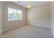 Neutral bedroom with a ceiling fan, carpet, and a bright window with blinds at 3527 E Indigo Cir, Mesa, AZ 85213