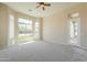 Spacious bedroom with neutral carpet, light paint, and large windows with natural light at 3527 E Indigo Cir, Mesa, AZ 85213