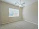 Spacious bedroom features neutral carpet, ceiling fan and a large bright window at 3527 E Indigo Cir, Mesa, AZ 85213