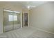 Bedroom with a ceiling fan, mirrored closet doors, and carpet flooring at 3527 E Indigo Cir, Mesa, AZ 85213