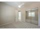 Cozy bedroom with carpet flooring, ceiling fan, and mirrored closet doors at 3527 E Indigo Cir, Mesa, AZ 85213