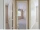 View of bedroom through doorway showcasing neutral color palette, carpet, and ceiling fan at 3527 E Indigo Cir, Mesa, AZ 85213