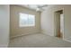 Bedroom features a ceiling fan and a bright window with blinds at 3527 E Indigo Cir, Mesa, AZ 85213