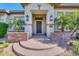 Close-up of front door, hardscape steps, decorative potted plant, and front windows at 3527 E Indigo Cir, Mesa, AZ 85213