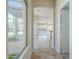 Hallway leading to living spaces, showing tile flooring, and a view to outdoor spaces at 3527 E Indigo Cir, Mesa, AZ 85213