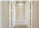 Hallway through a pair of open doors, showing neutral walls and carpet in the room ahead at 3527 E Indigo Cir, Mesa, AZ 85213