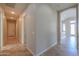 Tile hallway with an arched entryway and view of a front door and bright entryway at 3527 E Indigo Cir, Mesa, AZ 85213