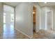 Inviting hallway with tile flooring leads to various rooms and a conveniently located powder room at 3527 E Indigo Cir, Mesa, AZ 85213