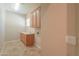 Bright laundry room featuring upper cabinets and a utility sink at 3527 E Indigo Cir, Mesa, AZ 85213