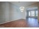 Spacious living room with wood floors, decorative wall, and modern chandelier lighting at 3527 E Indigo Cir, Mesa, AZ 85213