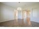 Bright living room with wood floors, modern chandelier, and an open view of the hallway at 3527 E Indigo Cir, Mesa, AZ 85213