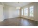 Spacious living room with decorative wall panels and large window, creating a bright, inviting space at 3527 E Indigo Cir, Mesa, AZ 85213