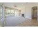 Large, bright living room with a fireplace, recessed lighting, and expansive windows at 3527 E Indigo Cir, Mesa, AZ 85213