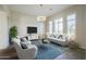 Cozy living room featuring decorative walls, modern chandelier, and large window at 3527 E Indigo Cir, Mesa, AZ 85213