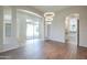 Open living area with wood floors, modern lighting, seamless transition to the outdoor patio at 3527 E Indigo Cir, Mesa, AZ 85213