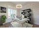 Stylish home office with plantation shutters and a modern chandelier at 3527 E Indigo Cir, Mesa, AZ 85213