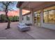 Covered patio with a swing bed, offering a relaxing outdoor space with views of the landscaped backyard at sunset at 3527 E Indigo Cir, Mesa, AZ 85213