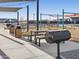 Outdoor barbecue area with charcoal grills, picnic tables, and a shade structure offers a great space for cookouts at 37357 W San Clemente St, Maricopa, AZ 85138