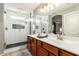 Modern bathroom featuring double sinks and an upgraded shower with tiled accents at 3763 S Laurel Way, Chandler, AZ 85286