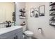 Stylish half bathroom featuring modern fixtures, mountain-themed wall art, and a decorative herringbone accent wall at 3763 S Laurel Way, Chandler, AZ 85286