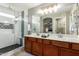 Bright bathroom featuring a double vanity, large mirror, and glass-enclosed shower at 3763 S Laurel Way, Chandler, AZ 85286