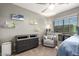 Cozy bedroom features neutral color scheme, chair, and a ceiling fan at 3763 S Laurel Way, Chandler, AZ 85286