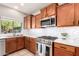 Close-up of kitchen featuring stainless steel appliances and a tiled backsplash, perfect for the home chef at 3763 S Laurel Way, Chandler, AZ 85286