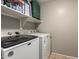 Functional laundry room with a front-load washer, a top-load dryer, and overhead storage shelves at 3763 S Laurel Way, Chandler, AZ 85286