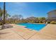 Community pool with sun loungers, landscaping, and clear blue water on a sunny day at 3763 S Laurel Way, Chandler, AZ 85286