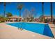 Community pool with a gazebo and clear blue water surrounded by palm trees and lounge chairs at 3763 S Laurel Way, Chandler, AZ 85286