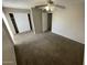 Neutral carpeted bedroom with white closet doors and a ceiling fan with a light fixture at 3840 N 43Rd Ave # 73, Phoenix, AZ 85031