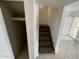 Staircase with carpet leading to the upper level and a storage space at 3840 N 43Rd Ave # 73, Phoenix, AZ 85031