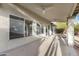 Covered back porch with ceiling fans and large windows overlooking the backyard at 4441 E Via Dona Rd, Cave Creek, AZ 85331