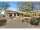 Backyard with desert landscaping, covered patio, and solar panels on the roof at 4441 E Via Dona Rd, Cave Creek, AZ 85331