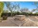 Backyard featuring a hot tub with surrounding desert landscaping and mature trees at 4441 E Via Dona Rd, Cave Creek, AZ 85331